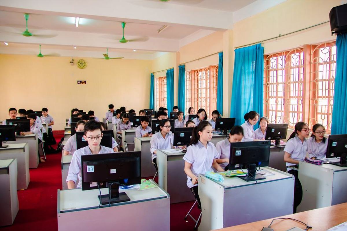 A classroom full of school students working at computers